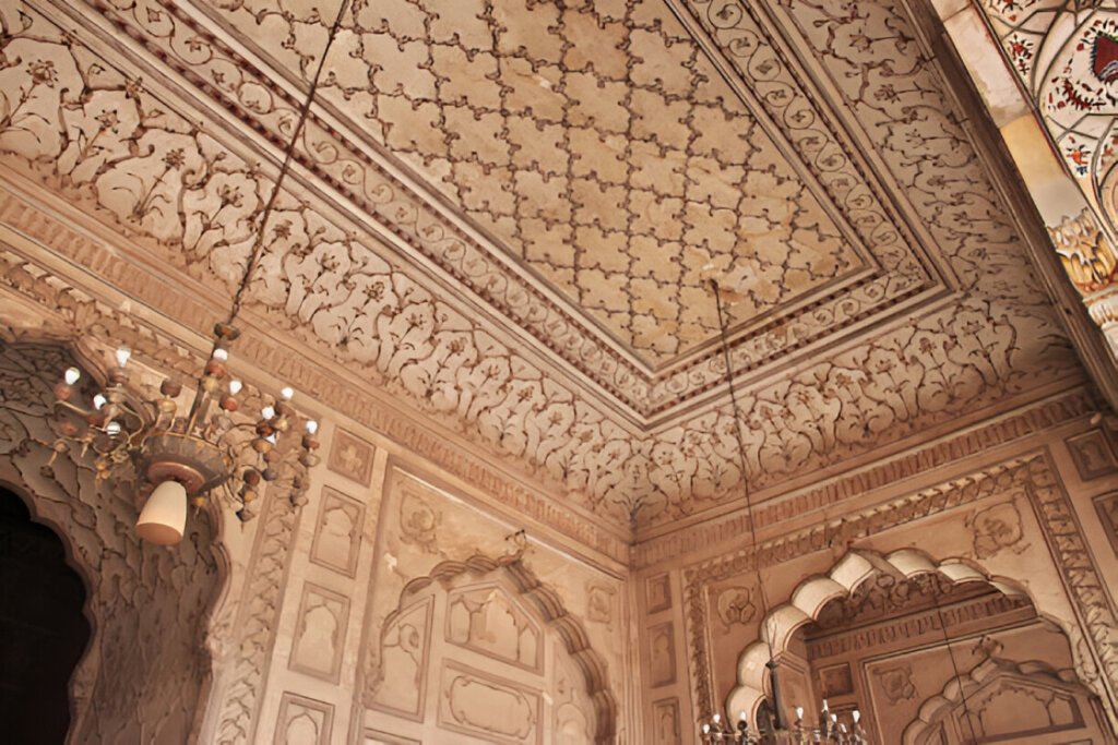 Intricate floral ornamentation carved in plaster on the ceiling and walls of the Badshahi Mosque.’s main prayer hall.